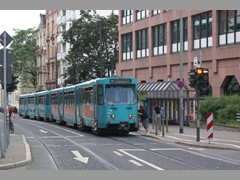 Die alte Station Glauburgstraße. Mühsam erktettert eine Dame den Ptb vom Starßenniveau aus.
